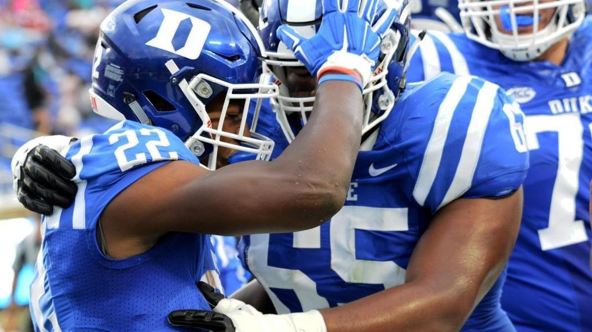 Duke’s Brittain Brown, left, celebrates his touchdown with Julian Santos, middle, against N.C. Central University on Saturday.