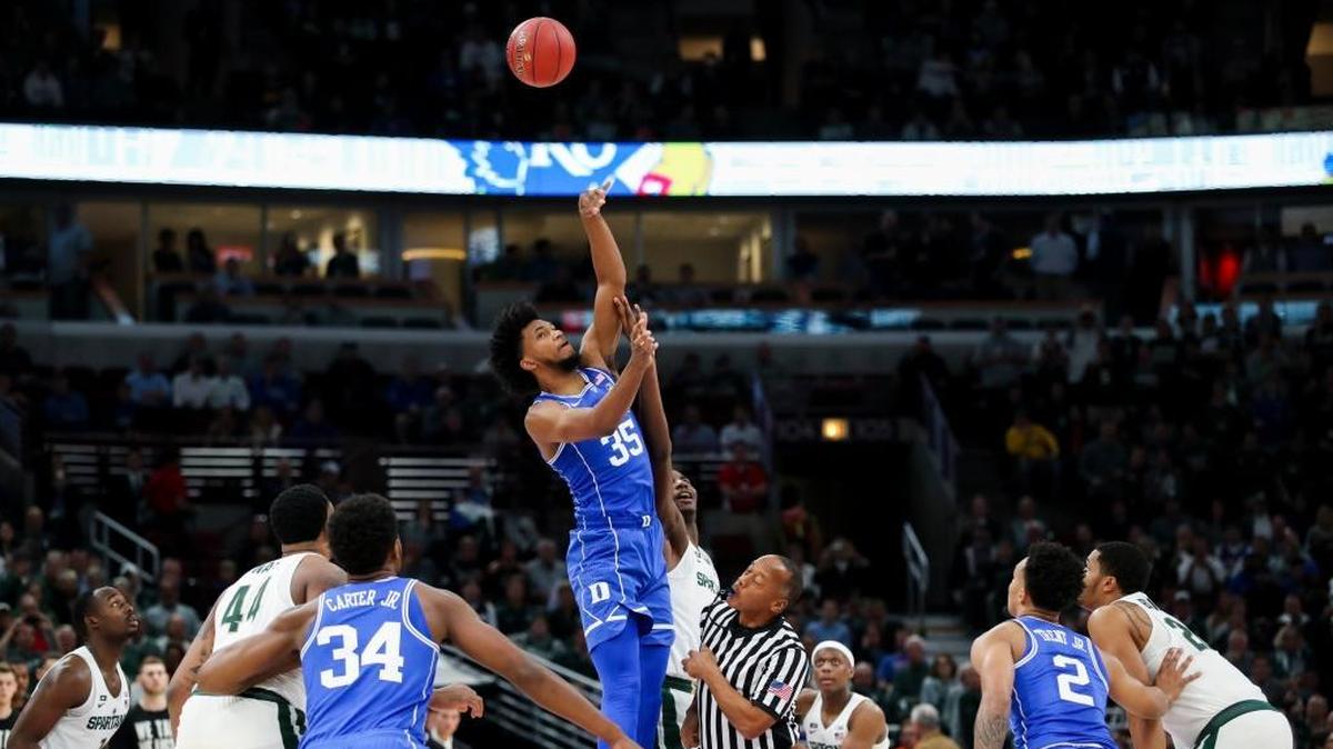 Duke forward Marvin Bagley III, middle in blue, gets possession of the ball over Michigan State forward Jaren Jackson Jr. during tipoff of the game on Nov. 14. Duke won, 88-81.