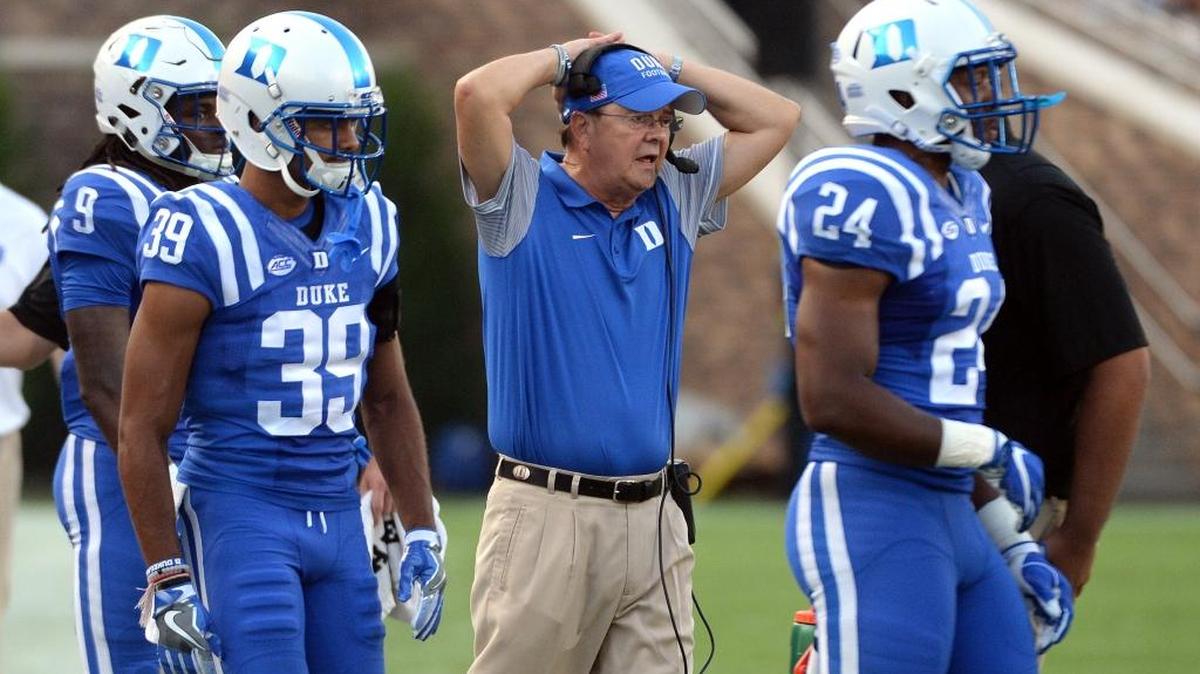 Duke coach David Cutcliffe, middle, holds his head as the Blue Devils are forced to stop the clock late in the fourth quarter against Wake Forest in September.