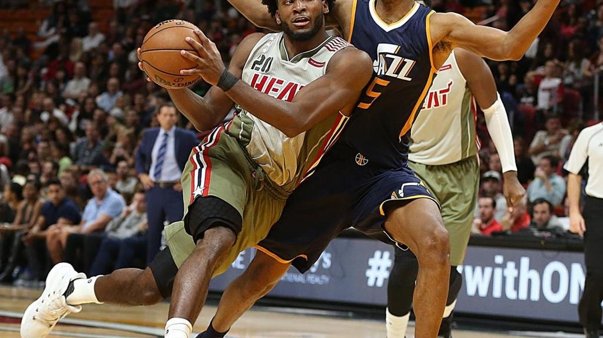 Utah guard Rodney Hood (right) defends fellow former Duke player Justise Winslow, left, of the Miami Heat during an NBA game at AmericanAirlines Arena in Miami last Nov. 12, 2016.