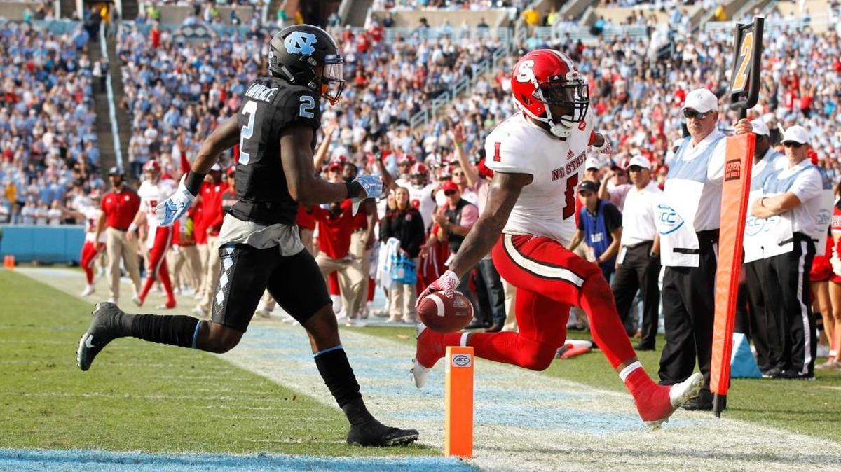 N.C. State’s Jaylen Samuels, right, scores a touchdown against North Carolina and Des Lawrence, left, in the Wolfpack’s 28-21 win over the Tar Heels in November.
