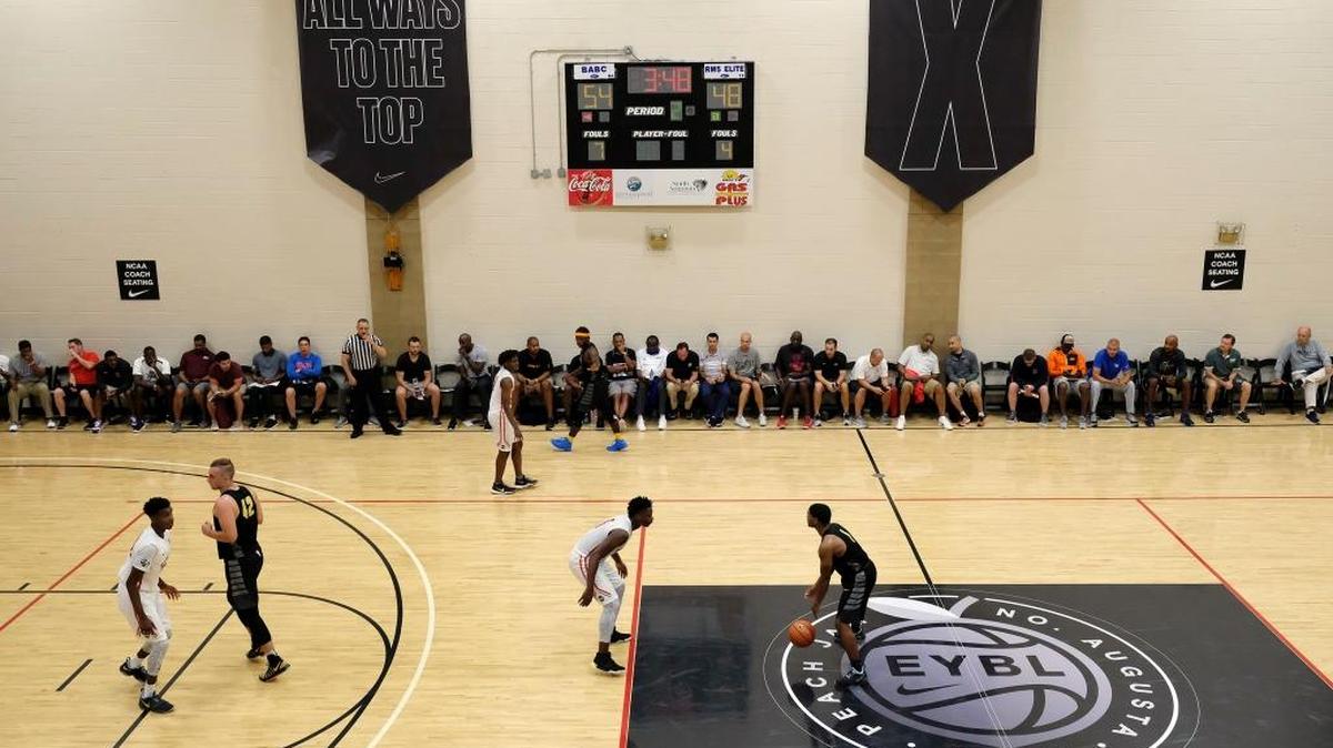 Basketball coaches watch a game during the opening night of the Nike Peach Jam at Riverview Park in North Augusta, S.C., Wednesday, July 12, 2017.