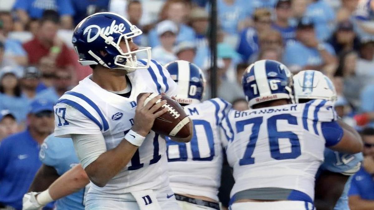 Daniel Jones, left, goes to make a pass behind the block of Gabe Brandner, 76, during Duke’s win at UNC on Sept. 23. Brandner suffered a hamstring injury against Virginia on Oct. 7 and may not play against Florida State on Oct. 14.