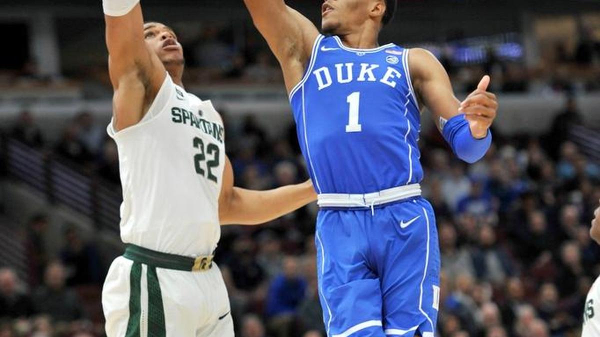 Duke’s Trevon Duval shoots over Michigan State’s Miles Bridges during the first half of game play in the Champions Classic in Chicago Tuesday night. See newsobserver.com for results from the game, which concluded after press deadline.