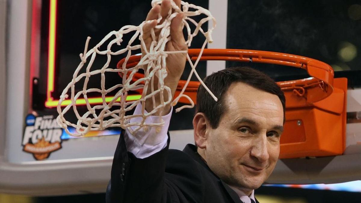 Duke coach Mike Krzyzewski holds up the net after defeating Butler 61-59 in the NCAA championship on April 5, 2010.