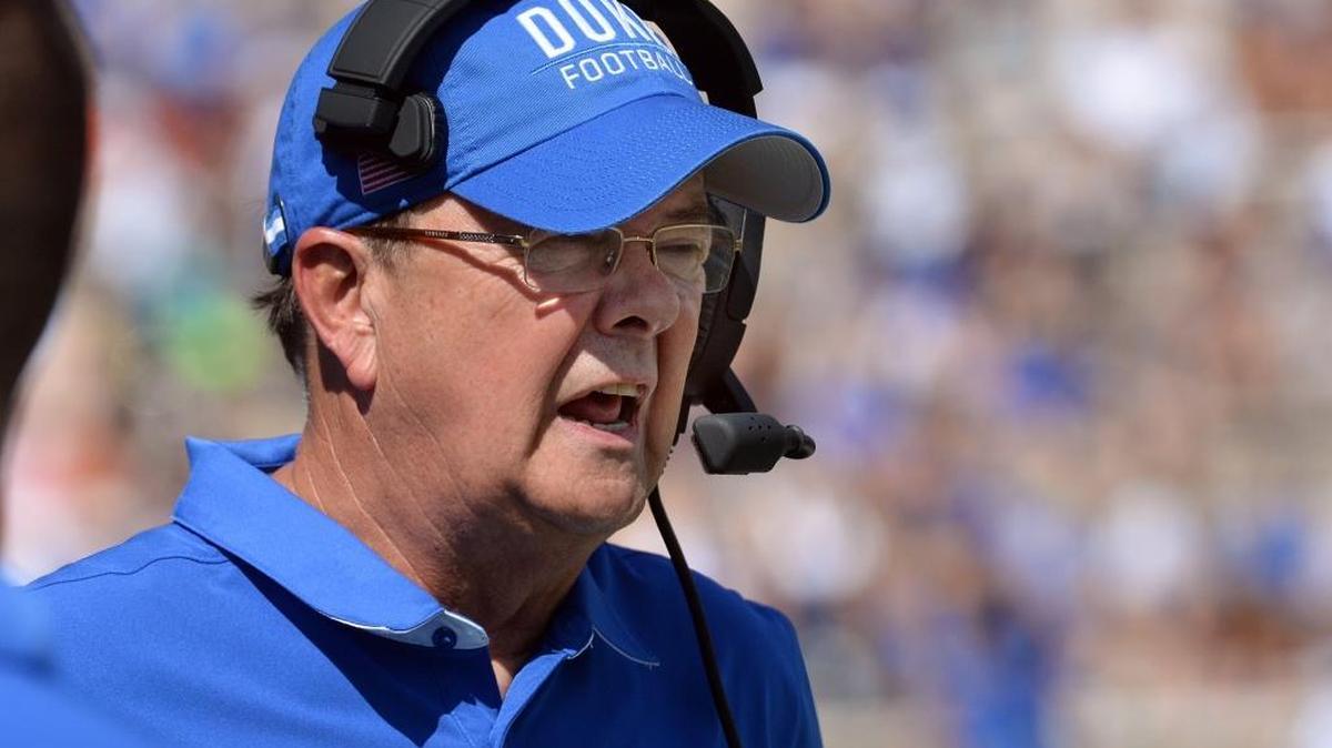 Duke coach David Cutcliffe speaks over his headphones to assistant coaches in October.