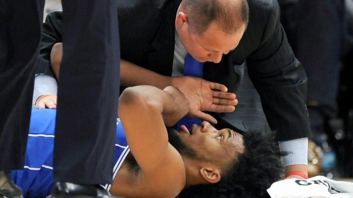 Duke assistant athletic trainer Jose Fonseca checks on forward Marvin Bagley III during the first half against Michigan State.