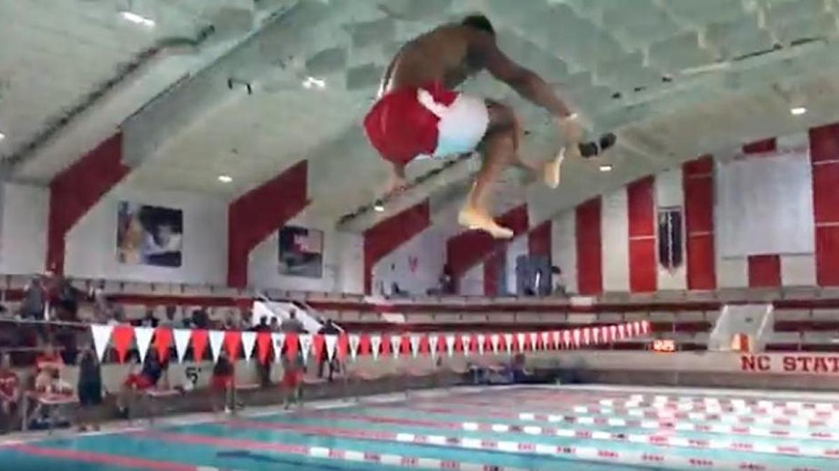 NC State football players do flips and have a cannonball at the campus pool on Aug. 20, 2017.