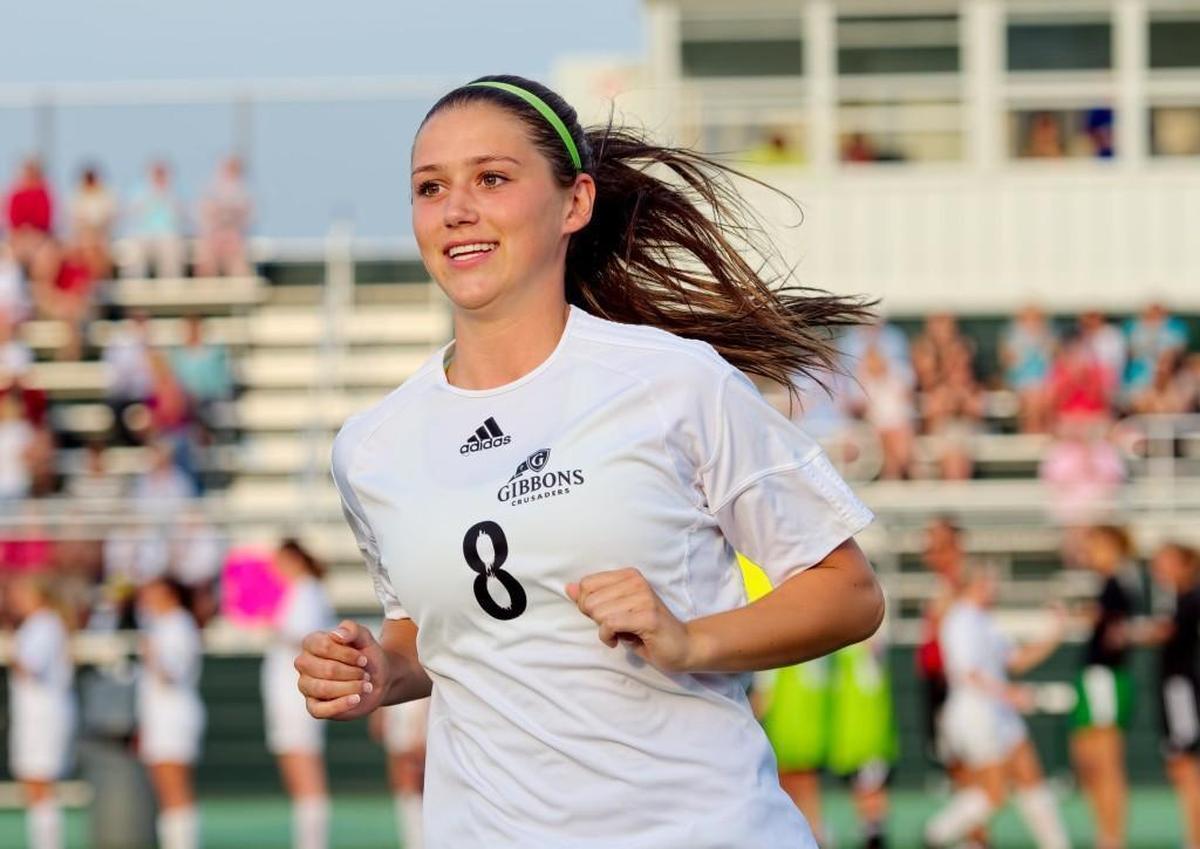 Cardinal Gibbons senior Morgan Reid (8) is announced during pre game introductions. The Chapel Hill Tigers played the Cardinal Gibbons Crusaders in the third round of the NCHSAA Women's Soccer Playoffs on Wednesday, May 21, 2014 in Raleigh, N.C. Chapel Hill won the game, 2-1.