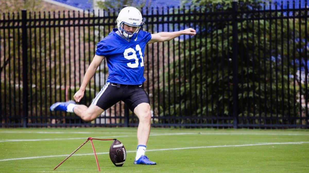 Willie Holmquist, the Duke kicker who is unable to hear clearly on the field, practices in August.