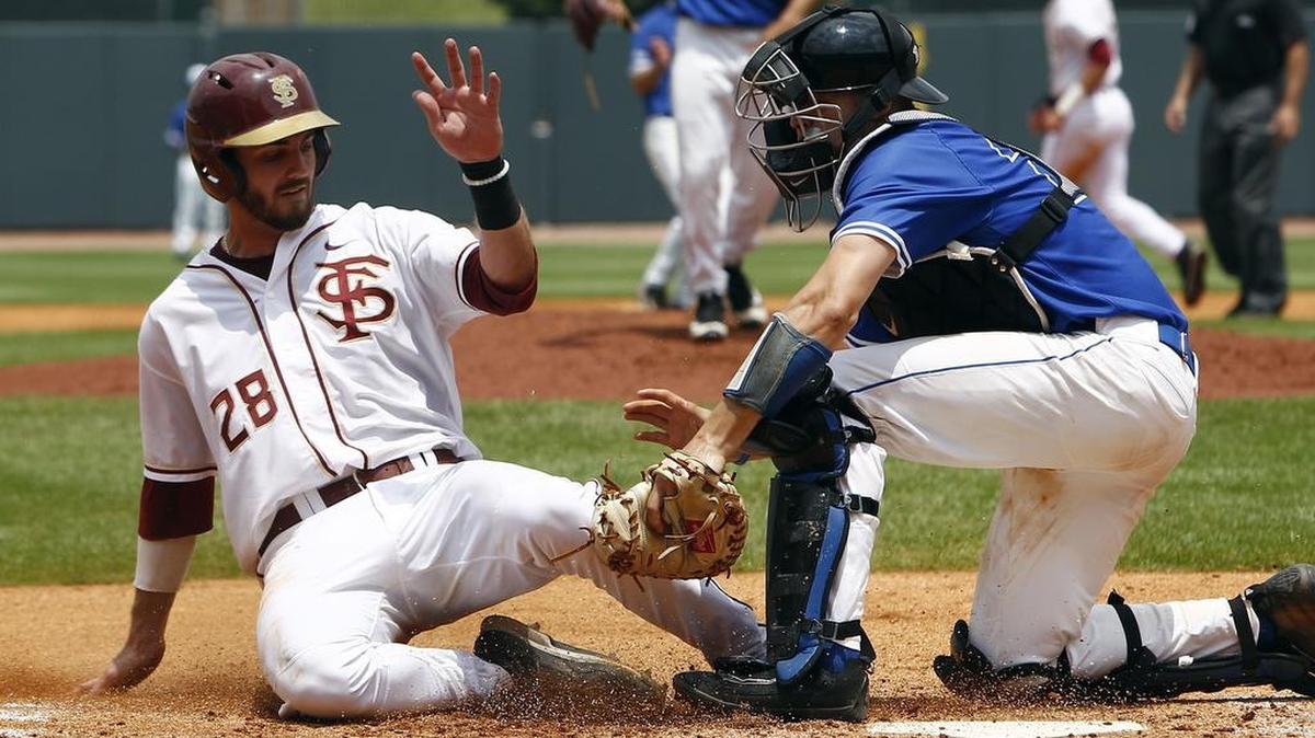 Florida State infielder Dylan Busby (28) is tagged out at the plate by Duke catcher Chris Proctor (23) during the ACC baseball tournament in Louisville, Ky., on Saturday.