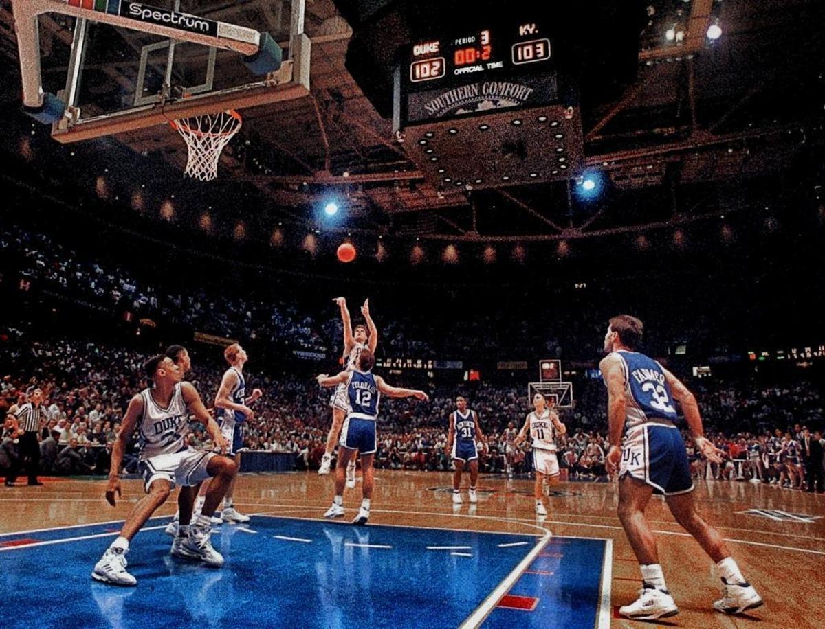 Duke’s Christian Laettner shoots over Kentucky’s Deron Feldhaus with 2.1 seconds left in overtime. “The Shot” sent the Blue Devils to the Final Four as Duke beat the Wildcats 104-103.