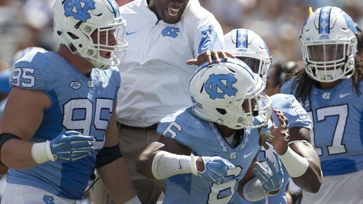 North Carolina defensive backs coach Carlton Warren congratulates M.J. Stewart (6) after is interception of Illinois quarterback Wes Lunt in 2015.