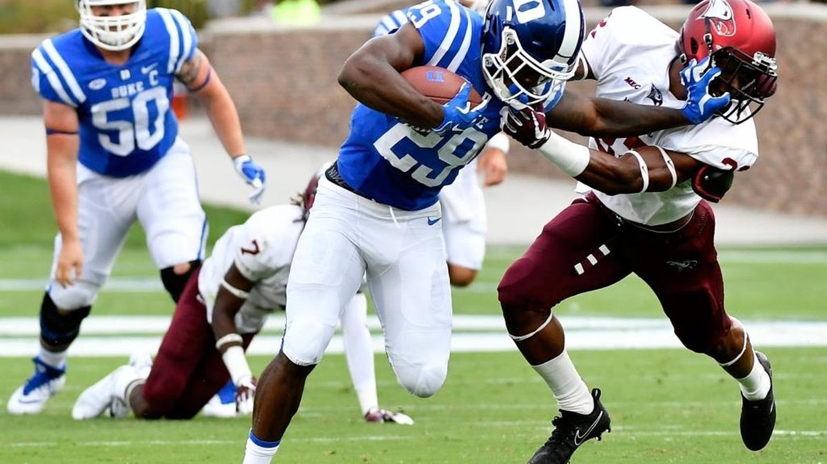 Duke running back Shaun Wilson stiff-arms NC Central defensive back Alden McClellon during the Blue Devils’ 60-7 win over the Eagles on Saturday.