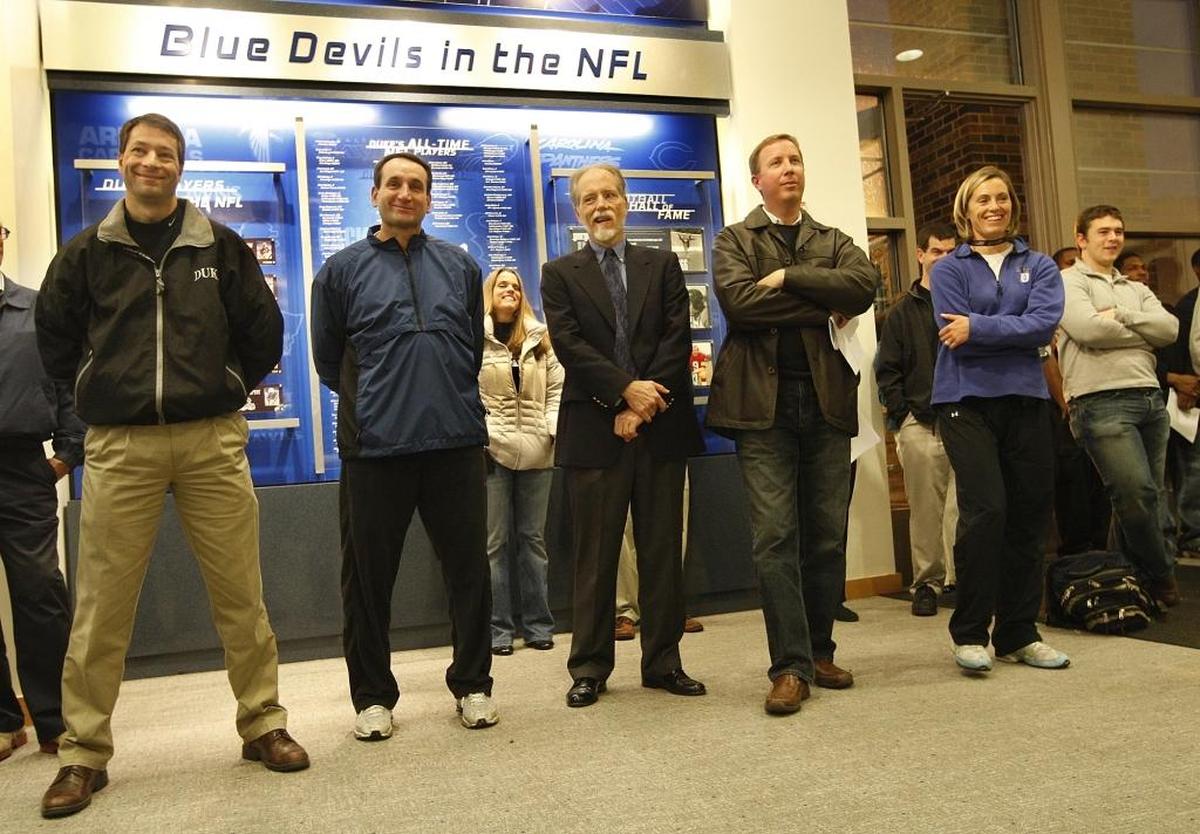 Duke head basketball coach Mike Krzyzewski, second from left, laughs as newly appointed football coach David Cutcliffe makes a joke about trying out for the basketball team on Dec. 15, 2007.