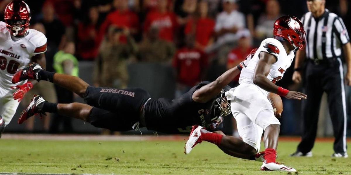 N.C. State defensive end Bradley Chubb (9) tackles Louisville quarterback Lamar Jackson (8) during the first half of N.C. State's game against Louisville at Carter-Finley Stadium on Oct. 5, 2017.