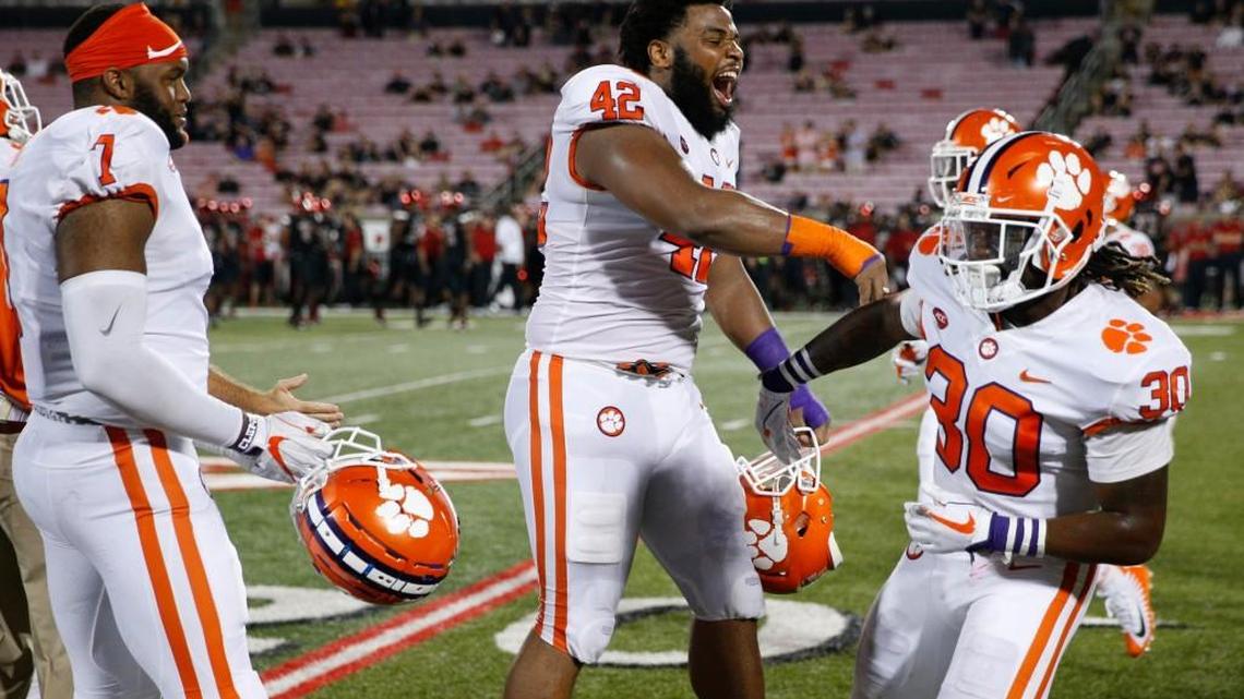Christian Wilkins #42 and Jalen Williams #30 of the Clemson Tigers celebrate in the fourth quarter of a game against the Louisville Cardinals at Papa John's Cardinal Stadium on September 16, 2017 in Louisville, Kentucky. Clemson won 47-21. (Photo by Joe Robbins/Getty Images)