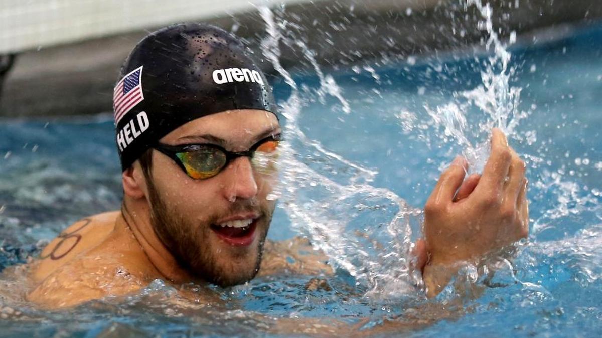 Ryan Held, who won a gold medal at the 2016 Olympics, cheers for other swimmers during the Brian's Mile of Hope Swim in June.