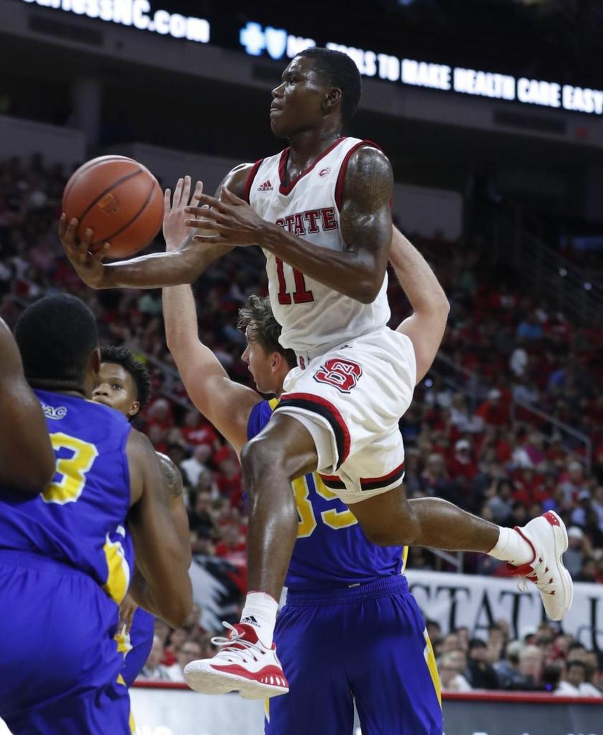 N.C. State's Markell Johnson (11) drives to the basket during the exhibition game against Mars Hill University at PNC Arena Friday, Nov. 3, 2017.