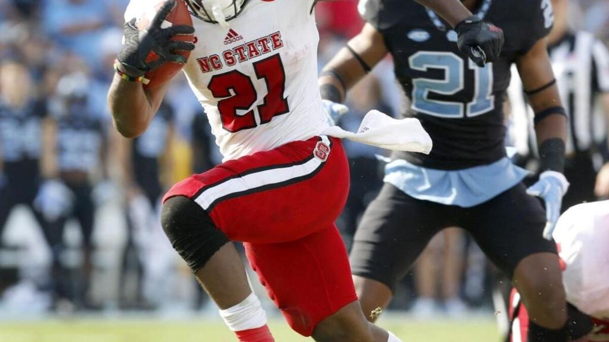N.C. State running back Matt Dayes breaks free for an 18-yard touchdown run against UNC in November.