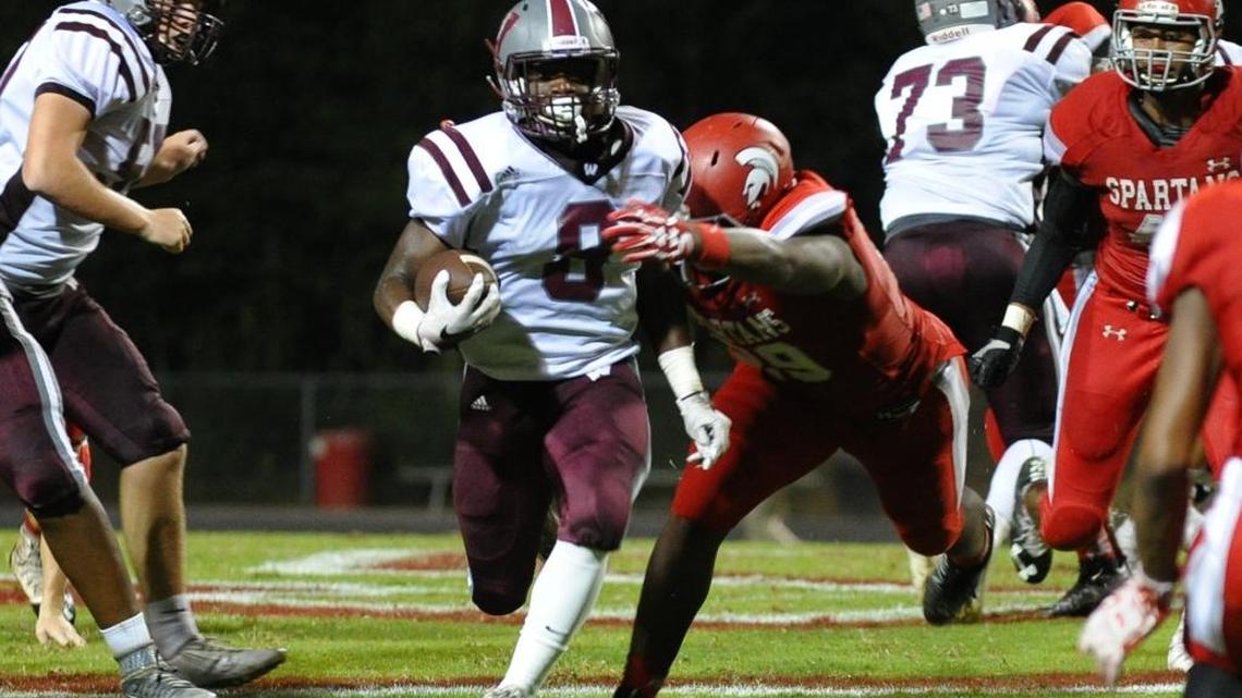 Wakefield's Chad Norfleet, middle left, is tackled by Sanderson's Alim McNeill, middle right, in 2016.