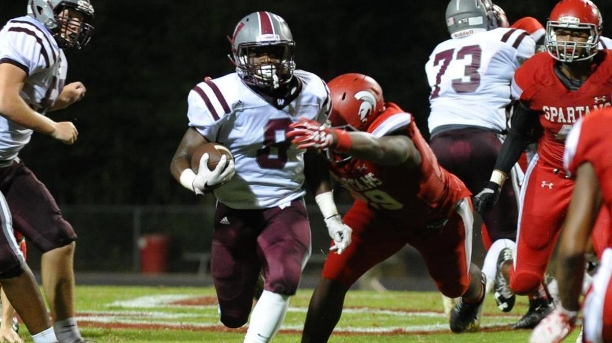 Wakefield’s Chad Norfleet, middle, is tackled by Sanderson’s Alim McNeill in 2016.
