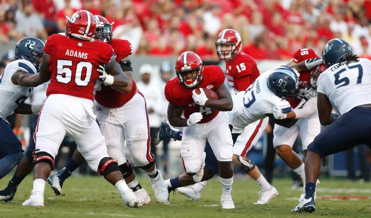N.C. State running back Reggie Gallaspy (4) runs through the hole against Old Dominion in September.