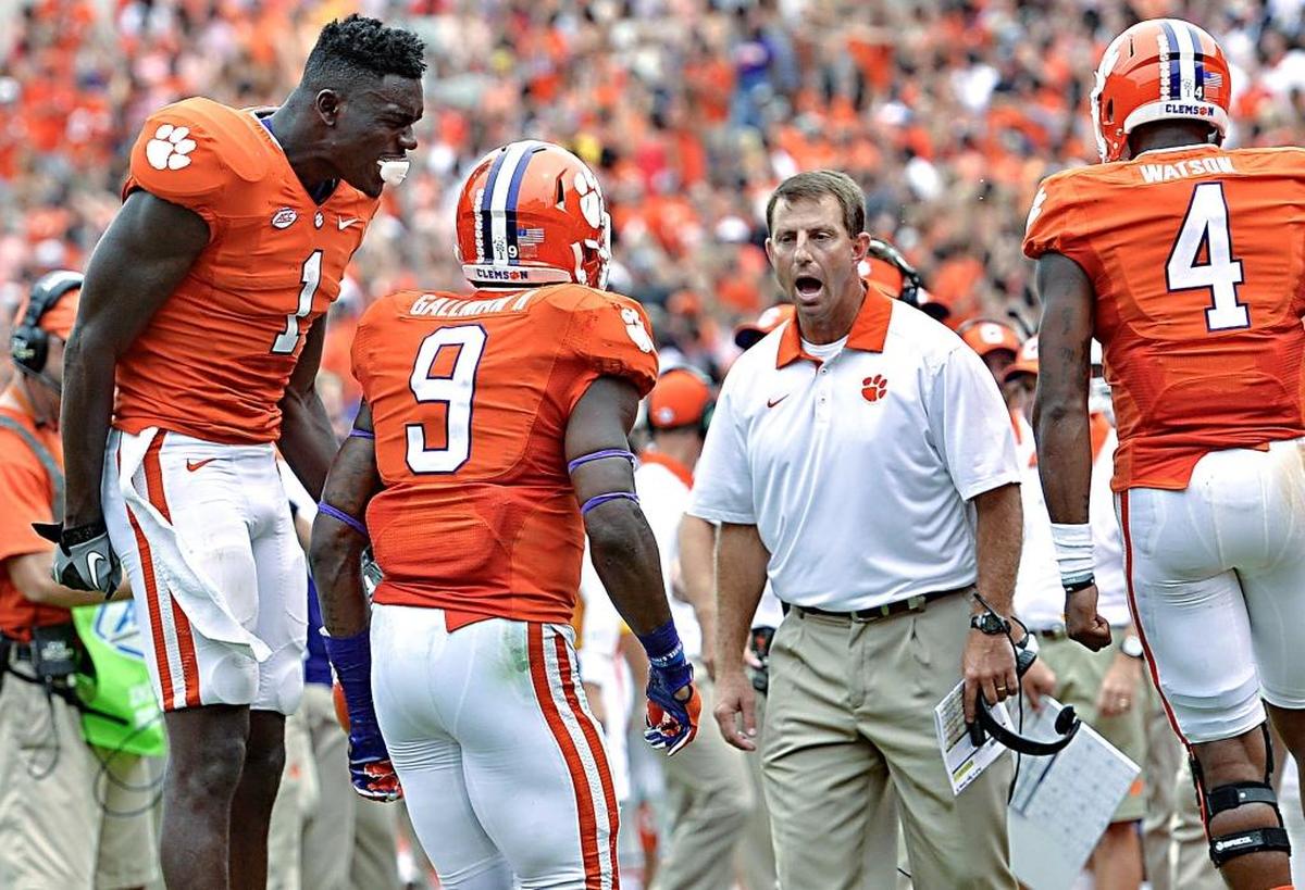 Clemson head coach Dabo Swinney, along with Deshaun Watson, right, and Jayron Kearse celebrate Charone Peake's touchdown during the second half against Appalachian State on Sept. 12, 2015, in Clemson, S.C. Clemson won 41-10. (AP Photo/Richard Shiro)