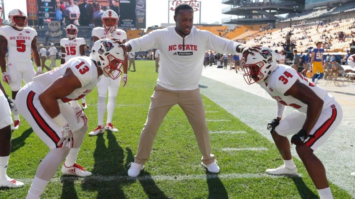 N.C. State safeties coach Aaron Henry works with Stephen Morrison (13) and Tim Kidd-Glass (34) before the Wolfpack's game against Pittsburgh at Heinz Field in Pittsburgh on Oct .14, 2017.