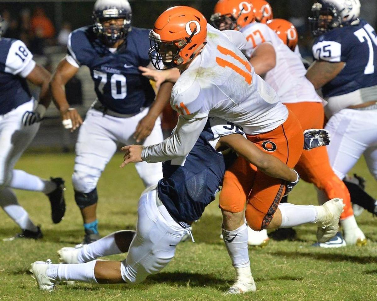 Hillside's Brendon Edgerton (32) tackles Orange's Payton Wilson (11) during the fourth quarter.The Orange Panthers visited the Hillside Hornets in a high school football game on Oct. 13, 2017.