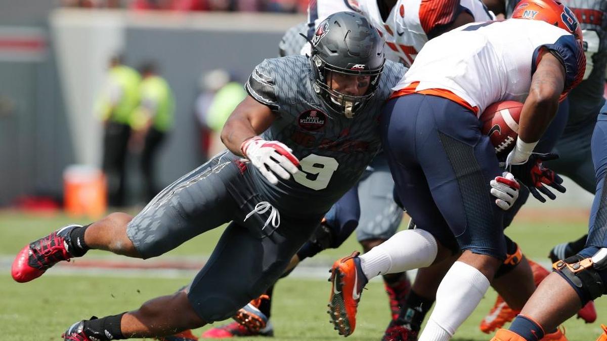 N.C. State defensive end Bradley Chubb (9) stops Syracuse running back Dontae Strickland (4) for a loss during the first half of N.C. State's game against Syracuse at Carter-Finley Stadium on Sept. 30, 2017.