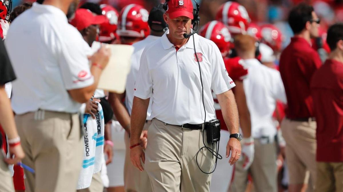 N.C. State head coach Dave Doeren walks the sidelines during the first half of N.C. State's game against South Carolina during the Belk College Kickoff at Bank of America Stadium in Charlotte Saturday, Sept. 2, 2017.