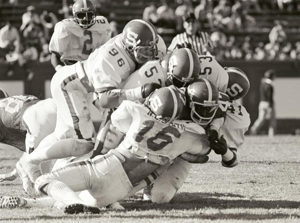 N.C. State’s Mike Nall (16), David Horning (96), Robert Abraham (53) and Steve Binder (41) tackle Duke’s Greg Rhett during their game on Nov. 17, 1979. State won the game 28-7.