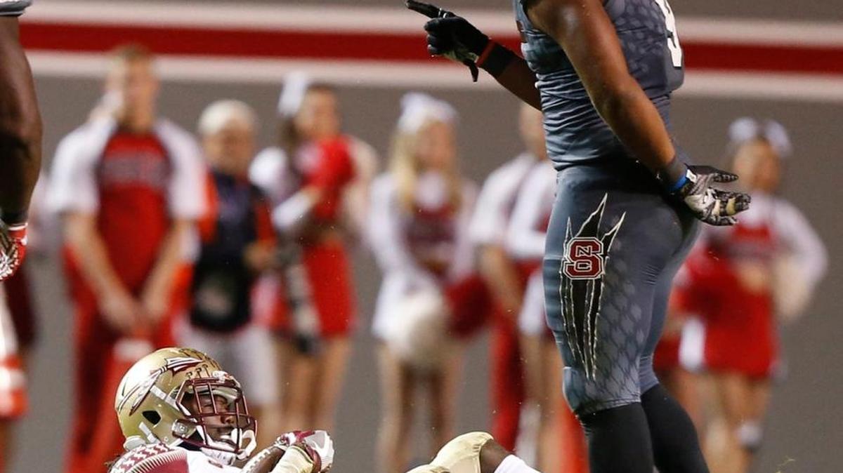 N.C. State defensive end Bradley Chubb, right, stands over Florida State's running back Dalvin Cook after stopping him for a loss in November.