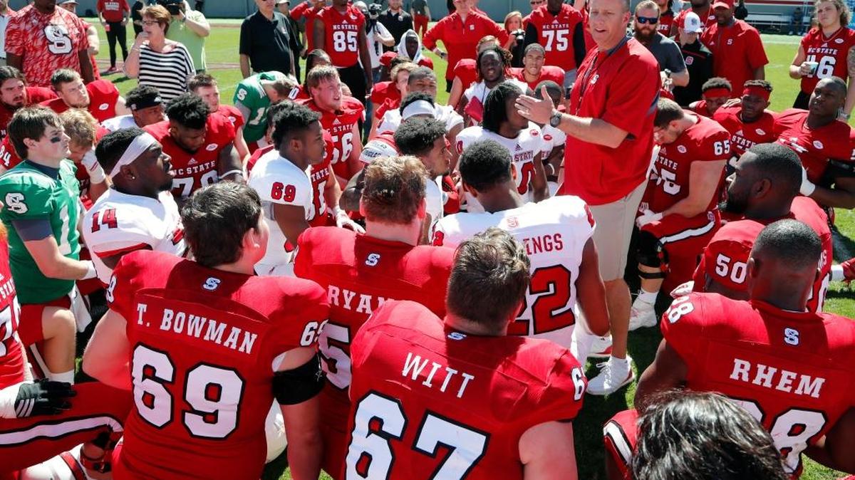 Wolfpack coach Dave Doeren talks to the players at the end of the spring game in April.