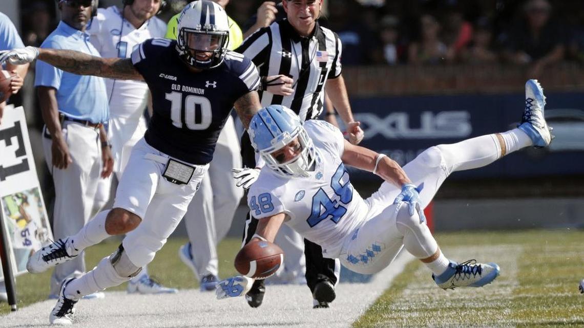 UNC’s Thomas Jackson, right, flies through the air as he is upended by ODU’s Andre Bernhard, left, during the game between the Tar Heels and the Monarchs on Saturday.