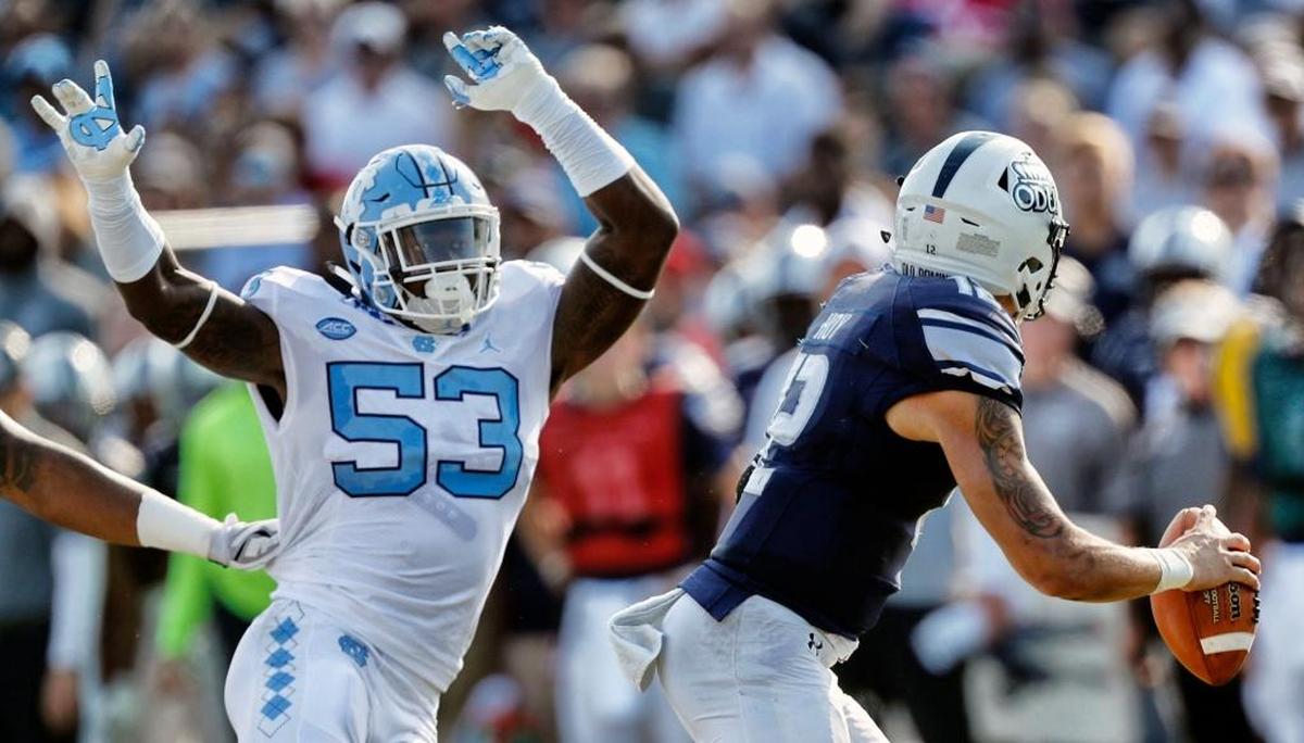 UNC's Malik Carney (53) pressures ODU's Jordan Hoy (12) during the first quarter.