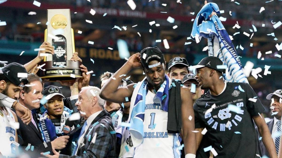 UNC coach Roy Williams and his team are peppered with confetti after beating Gonzaga 71-65 in the national championship on April 3.