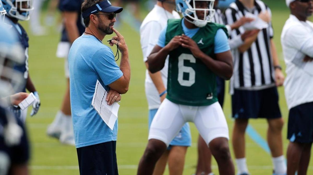 UNC coach Larry Fedora, left, watches Brandon Harris during a drill on Aug. 2.