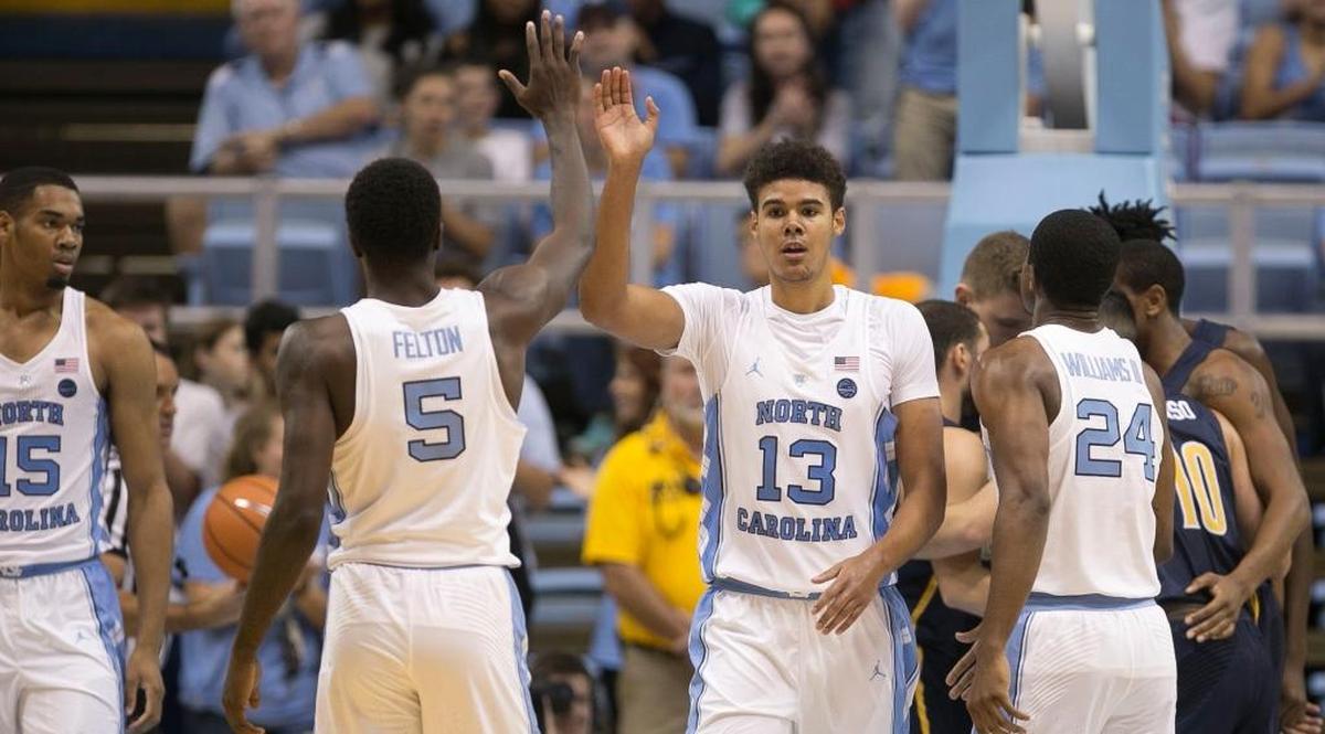 North Carolina’s Jalek Felton, 5, congratulates teammate Cameron Johnson, 13, after Johnson sank a basket and drew a foul against UNC-G during the North Carolina Disaster Relief Jamboree on Nov. 5.