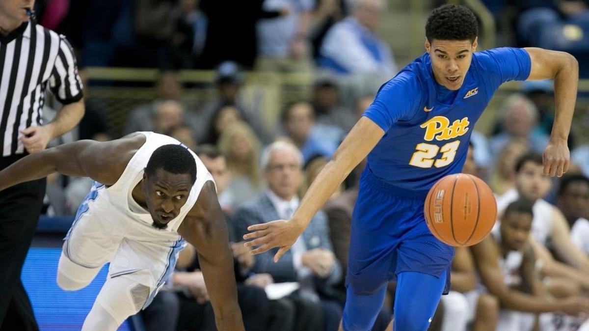 North Carolina’s Theo Pinson, left, and Pitt’s Cameron Johnson, right, chase down a loose ball during Pitt’s 85-67 loss to the Tar Heels.