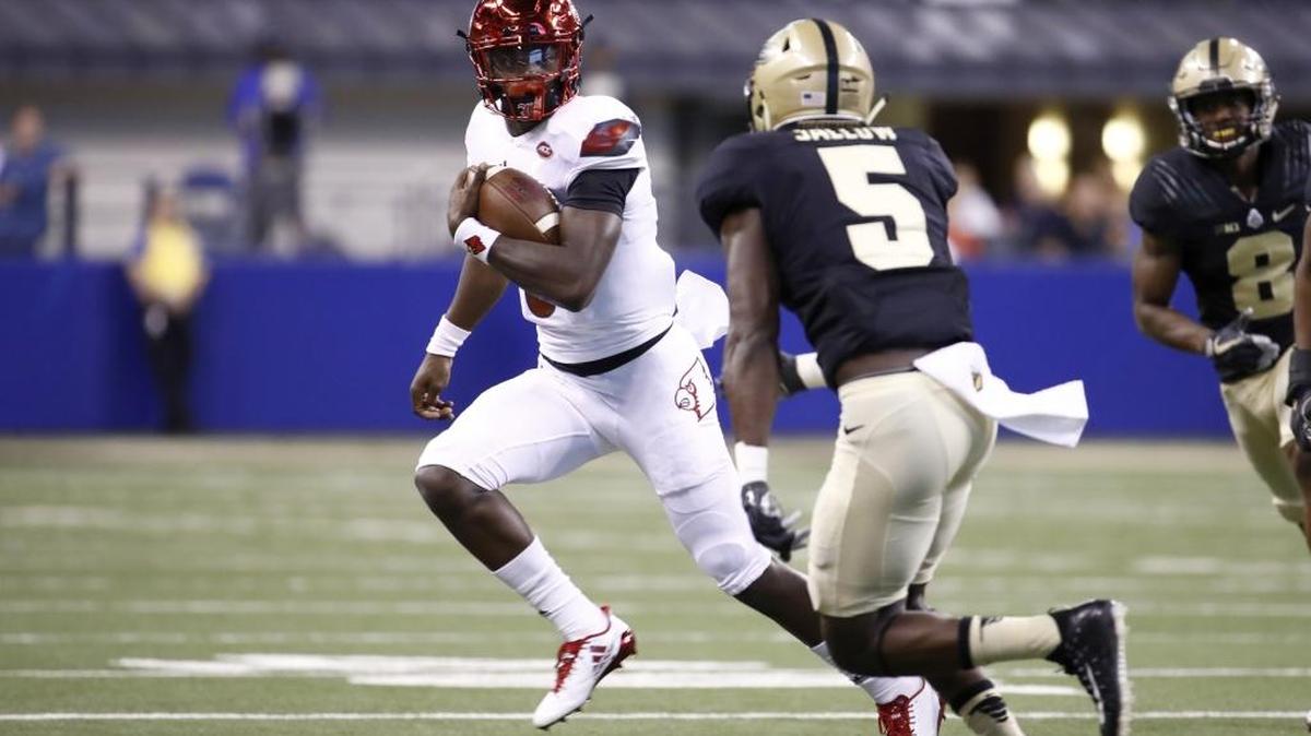 Louisville’s Lamar Jackson, left, runs with the ball against Purdue on Sept. 2. Louisville plays UNC Saturday in Chapel Hill.