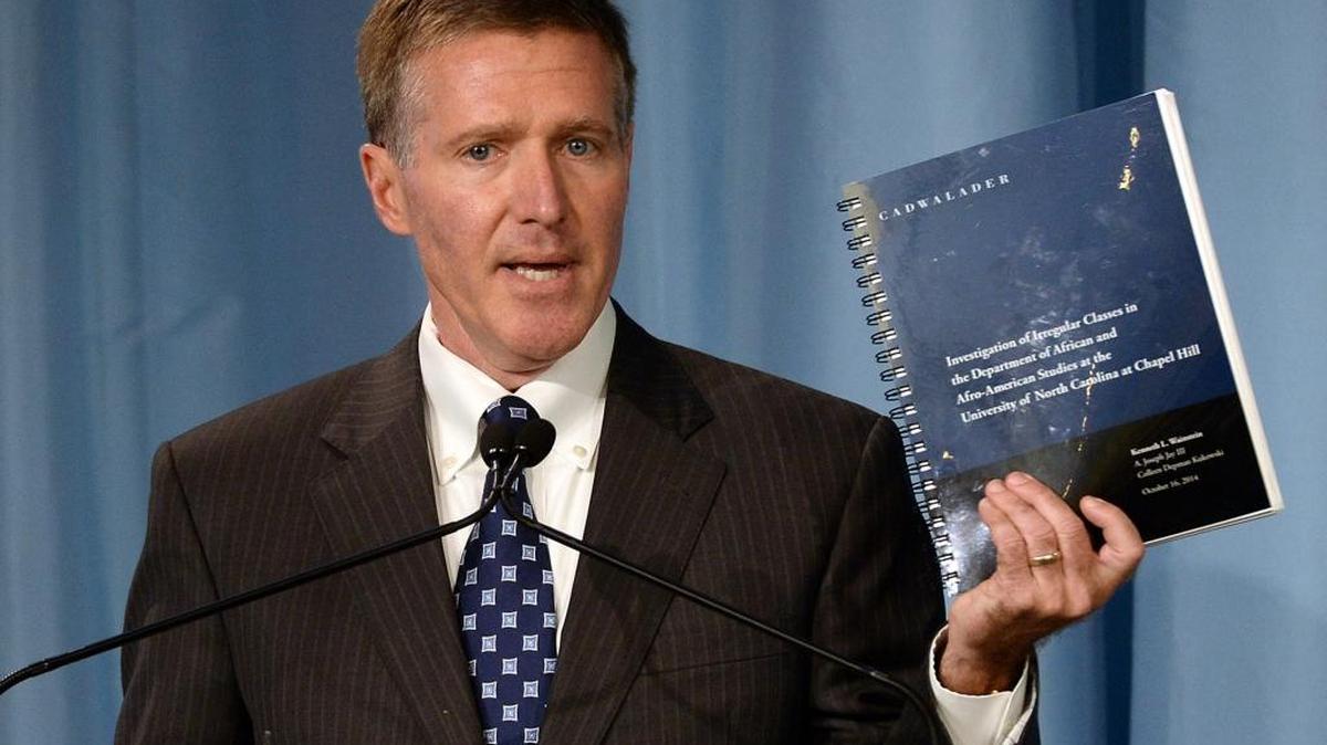 Kenneth Wainstein, a partner with Cadwalader, Wickersham & Taft LLP, holds up a report detailing accounts of academic fraud in association with the athletic department at UNC during a press conference Oct. 22, 2014.