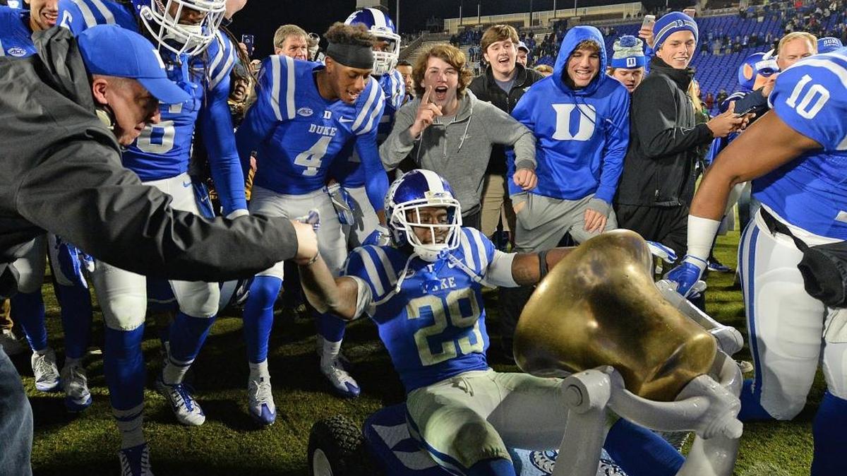 Duke running back Shaun Wilson (29) takes a ride on the Victory Bell after Duke beat North Carolina 28-27 at Walllace Wade Stadium in Durham, N.C., Thursday, Nov. 10, 2016.