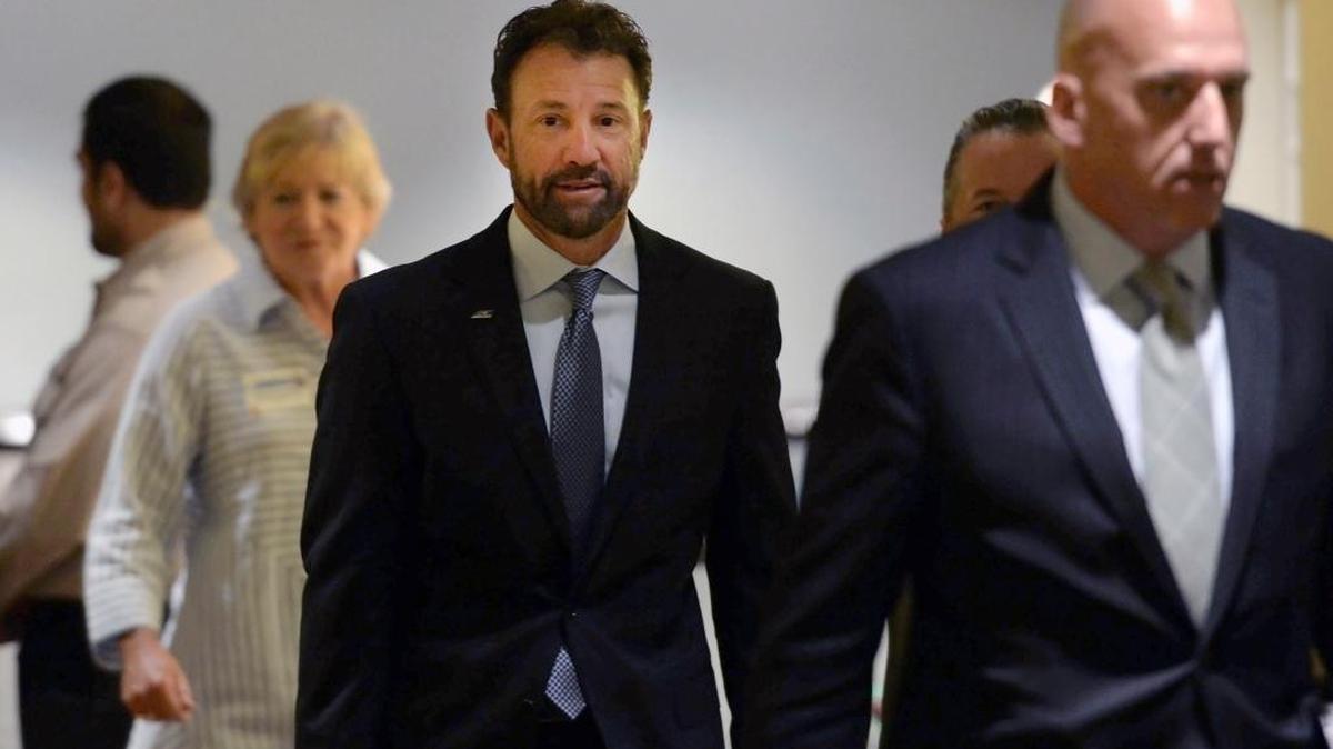North Carolina football coach Larry Fedora, center, arrives at an NCAA hearing on Wednesday. It has taken more than two years for North Carolina to appear before an NCAA infractions committee panel since initially being charged with five top-level violations amid its long-running academic scandal.