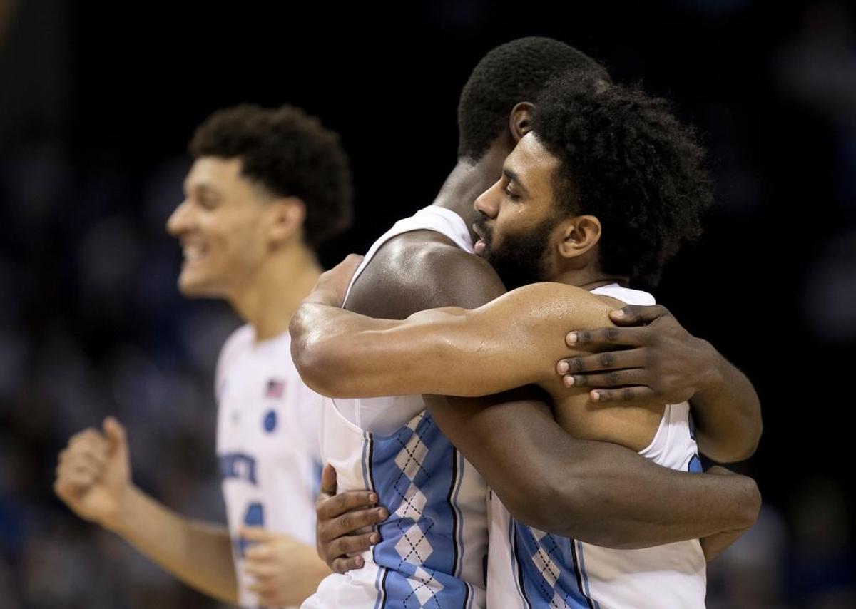 North Carolina’s Joel Berry II embraces Theo Pinson, right, as they begin their celebration following the Tar Heels 75-73 victory over Kentucky in the NCAA tournament in March.