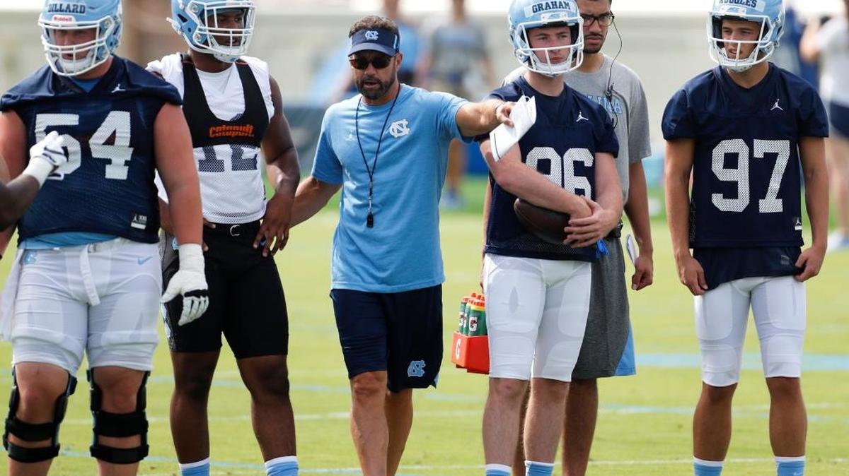 UNC coach Larry Fedora directs his players on the Tar Heels’ first day of football practice on Wednesday.