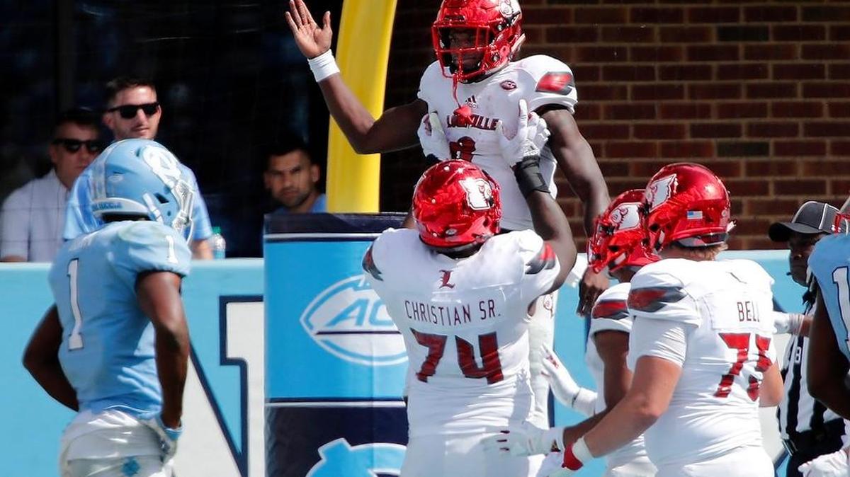 Louisville’s Lamar Jackson (8) celebrates with Geron Christian (74) and Robbie Bell (75) after he scored during the fourth quarter in a game between UNC and Louisville at Kenan Stadium in Chapel Hill on Sept. 9, 2017. Dejected Tar Heel is Myles Dorn (1).