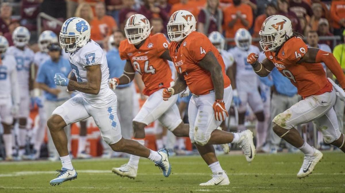 North Carolina wide receiver Anthony Ratliff-Williams (17) breaks away from Virginia Tech defensive players, Trevon Hill (94), Tim Settle (4), Tremaine Edmunds (49) for a touchdown, during the second half of an NCAA college football game, Saturday, Oct. 21, 2017, at Lane Stadium in Blacksburg, Va. Virginia Tech won 59-7. (AP Photo/Don Petersen)