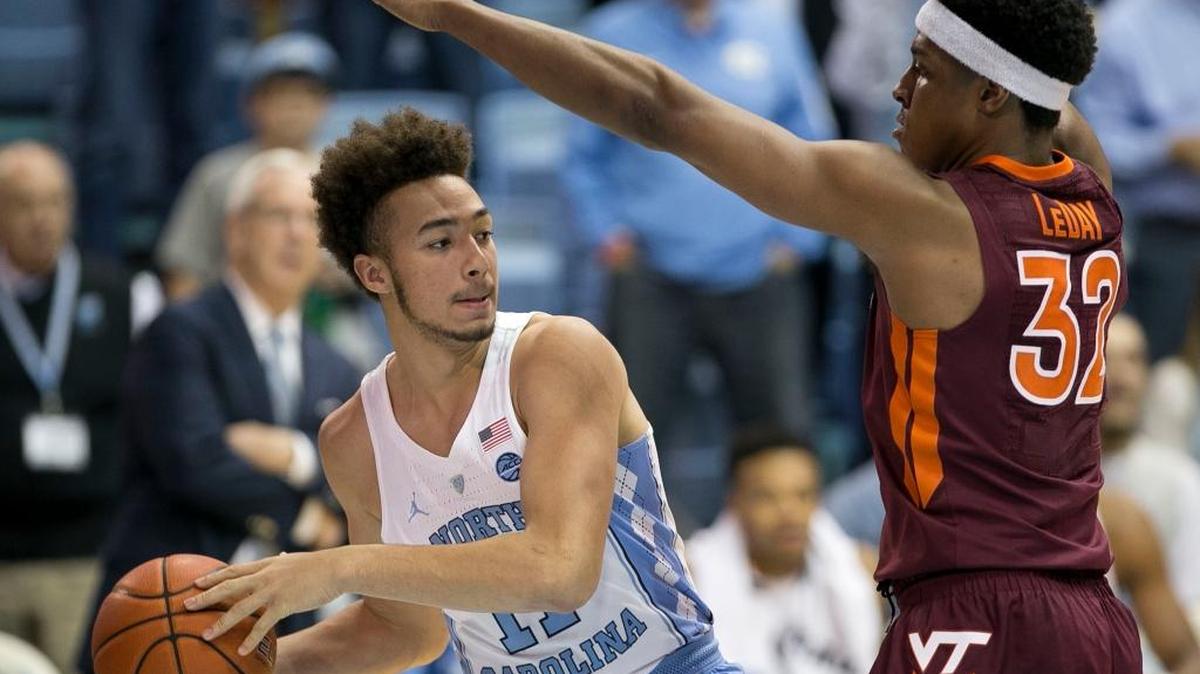 UNC’s Shea Rush, left, tries to pass around Virginias Tech’s Zach LeDay in January.